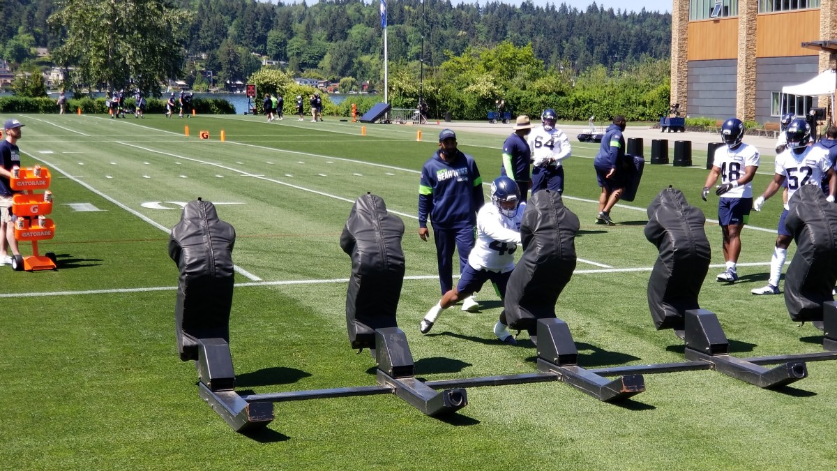 Seahawks rookie linebacker Aaron Donkor (#43) hits a sled during the team's opening rookie minicamp practice session.