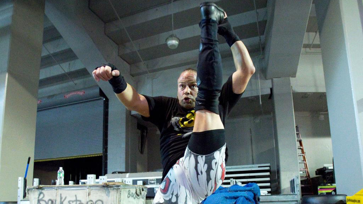 WWE wrestler Rob Van Dam stretches in anticipation of a match