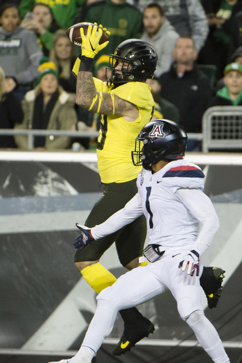 Spencer Webb hauls in a touchdown pass while linebacker Tony Fields defends in a game against the Arizona Wildcats on November 16, 2019. Oregon would win the game 34-6. 