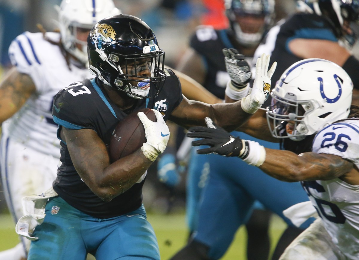Dec 29, 2019; Jacksonville, Florida, USA; Jacksonville Jaguars running back Ryquell Armstead (23) rushes against Indianapolis Colts safety Clayton Geathers (26) during the second half at TIAA Bank Field.
