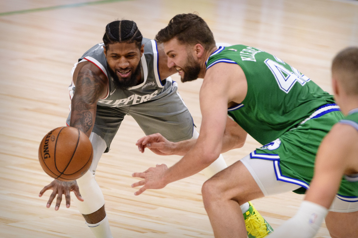 Mar 17, 2021; Dallas, Texas, USA; LA Clippers guard Paul George (13) and Dallas Mavericks forward Maxi Kleber (42) in action during the game between the Dallas Mavericks and the LA Clippers at the American Airlines Center. Mandatory Credit: Jerome Miron-USA TODAY Sports