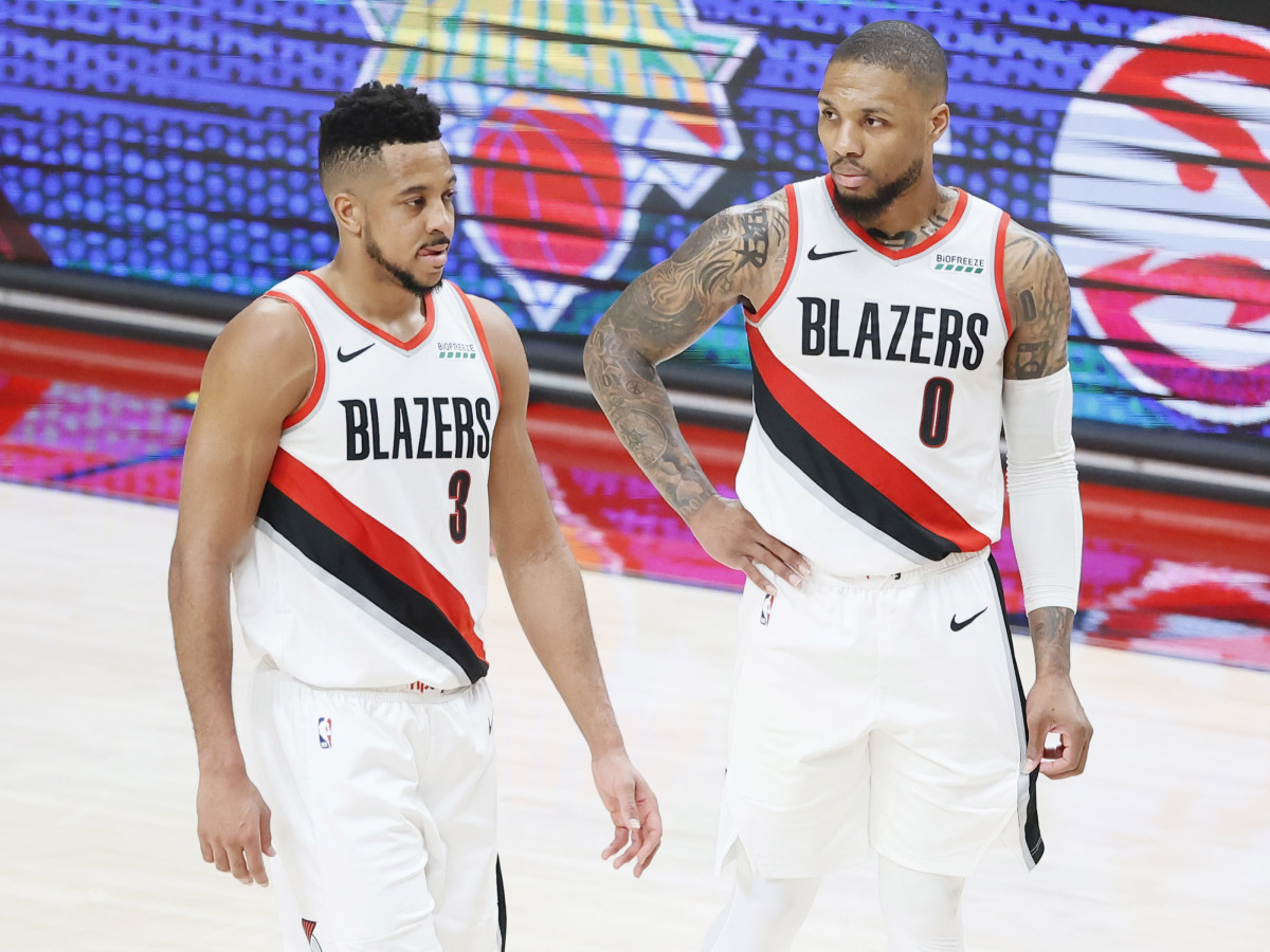 Portland Trail Blazers shooting guard CJ McCollum (3) and point guard Damian Lillard (0) walk back to the court after a timeout during the second half of game three in the first round