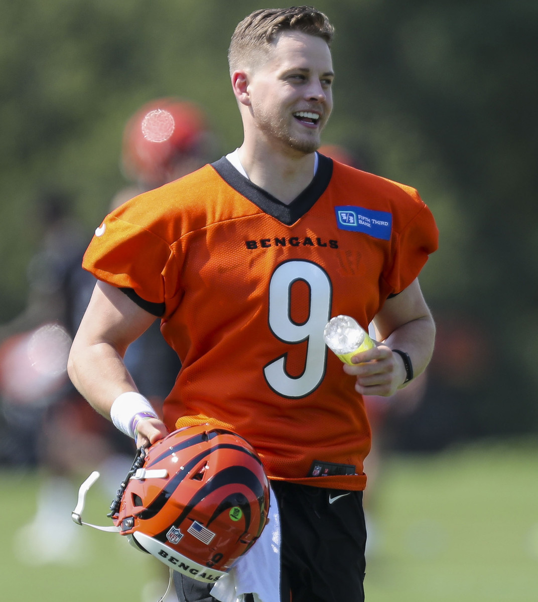 Joe Burrow smiles as he exits the field during 2021 OTAs