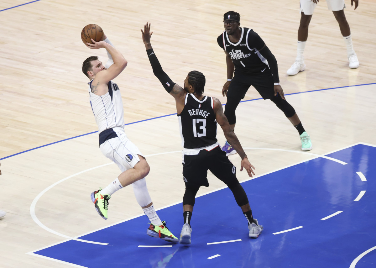 May 30, 2021; Dallas, Texas, USA; Dallas Mavericks guard Luka Doncic (77) shoots over LA Clippers guard Paul George (13) during the second quarter in game four in the first round of the 2021 NBA Playoffs at American Airlines Center. Mandatory Credit: Kevin Jairaj-USA TODAY Sports