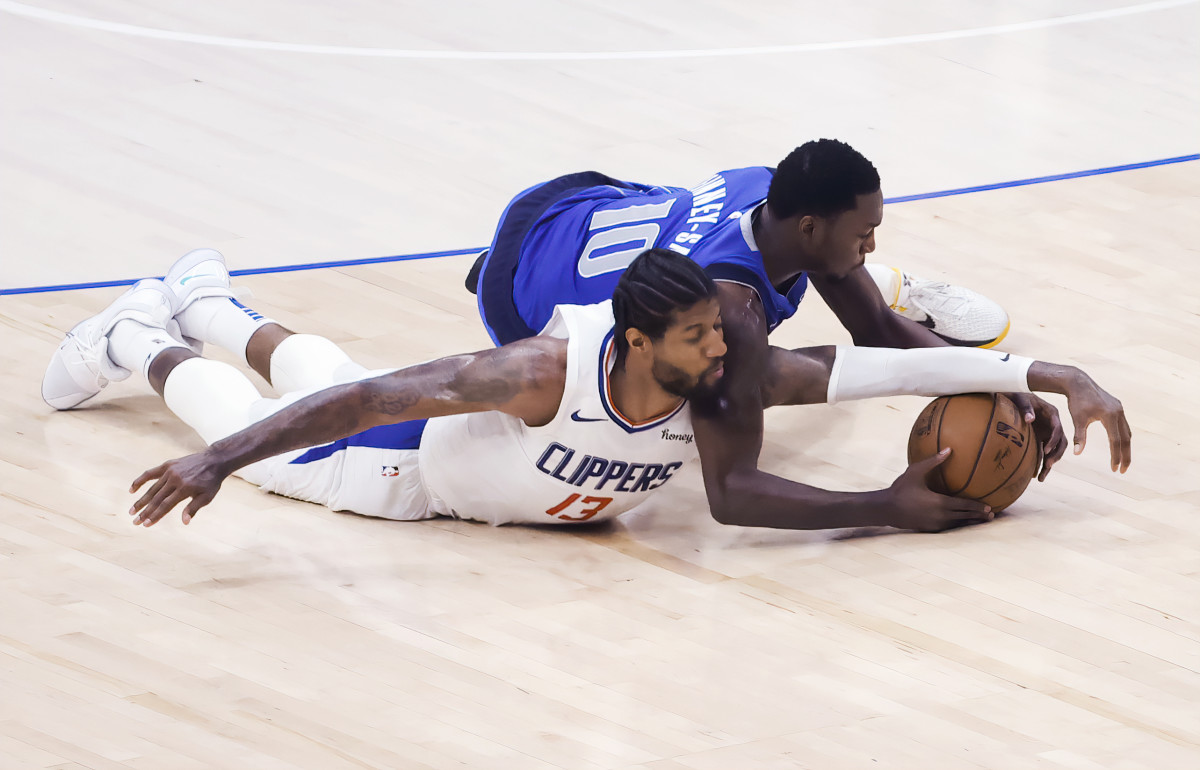 Jun 4, 2021; Dallas, Texas, USA; LA Clippers guard Paul George (13) and Dallas Mavericks forward Dorian Finney-Smith (10) dive for a loose ball during the second quarter during game six in the first round of the 2021 NBA Playoffs at American Airlines Center. Mandatory Credit: Kevin Jairaj-USA TODAY Sports
