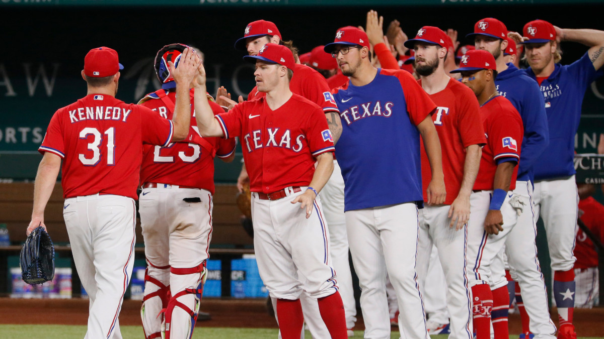 Jun 4, 2021; Arlington, Texas, USA; Texas Rangers relief pitcher Ian Kennedy (31) high fives teams after picking up the save against the Tampa Bay Rays at Globe Life Field.