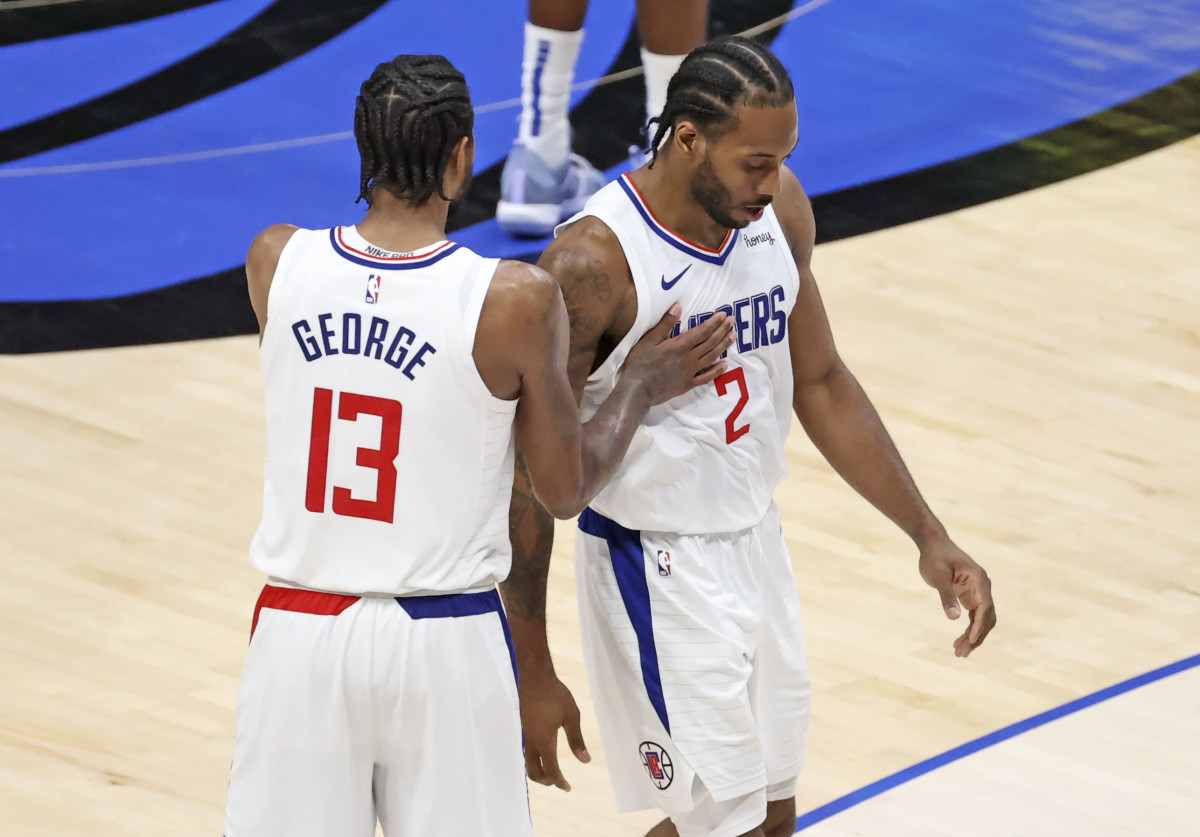 Jun 4, 2021; Dallas, Texas, USA; LA Clippers forward Kawhi Leonard (2) celebrates with guard Paul George (13) during the fourth quarter against the Dallas Mavericks during game six in the first round of the 2021 NBA Playoffs at American Airlines Center. Mandatory Credit: Kevin Jairaj-USA TODAY Sports