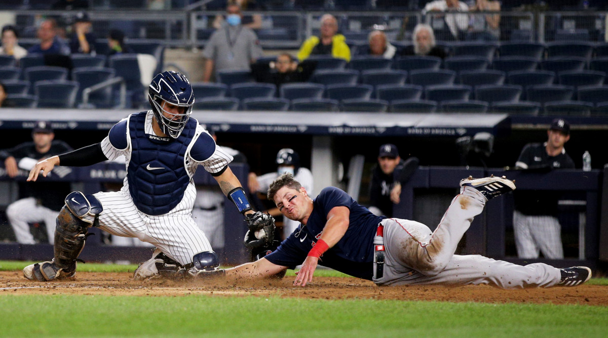 June 4, 2021; Bronx, New York, USA; Boston Red Sox right fielder Hunter Renfroe (10) slides safely into home ahead of the tag by New York Yankees catcher Gary Sánchez (24) on a double by Red Sox first baseman Marwin Gonzalez (not pictured) during the sixth inning at Yankee Stadium.