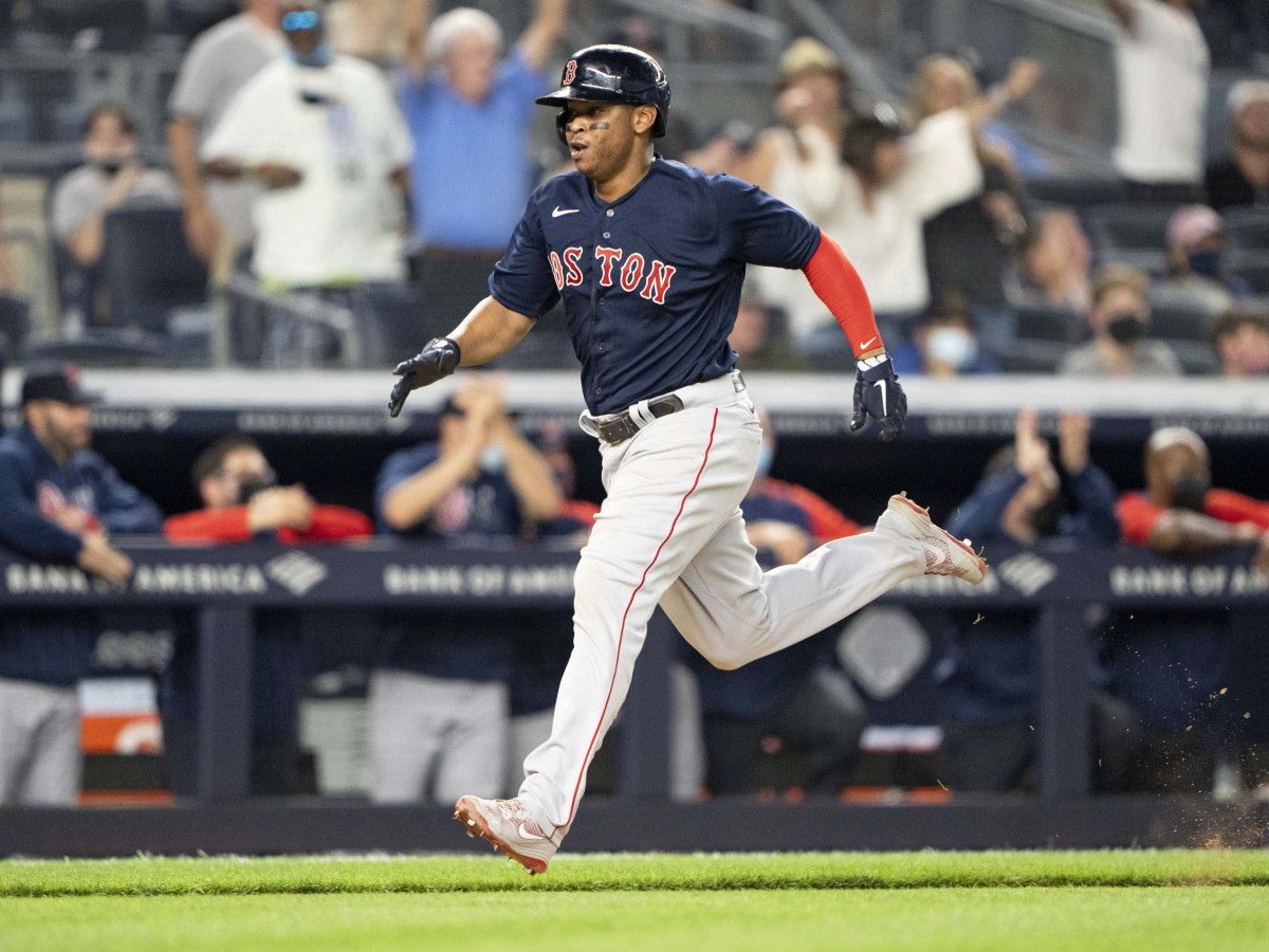 Jun 5, 2021; Bronx, New York, USA;  Boston Red Sox third baseman Rafael Devers (11) scores a run on Boston Red Sox center fielder Enrique Hernandez (5) (not pictured) RBI double during the eighth inning against the New York Yankees at Yankee Stadium.