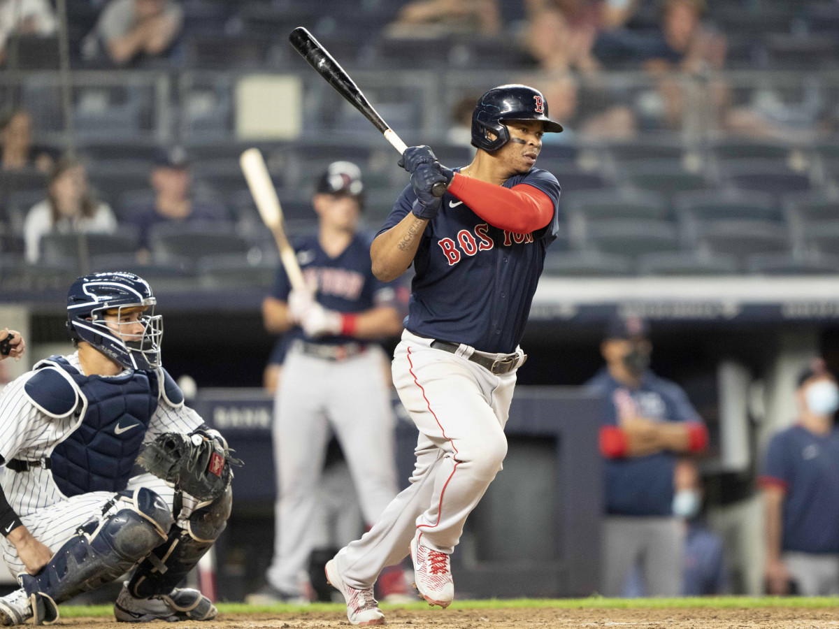 Jun 5, 2021; Bronx, New York, USA;  Boston Red Sox third baseman Rafael Devers (11) hits an RBI single during the sixth inning against the New York Yankees at Yankee Stadium.