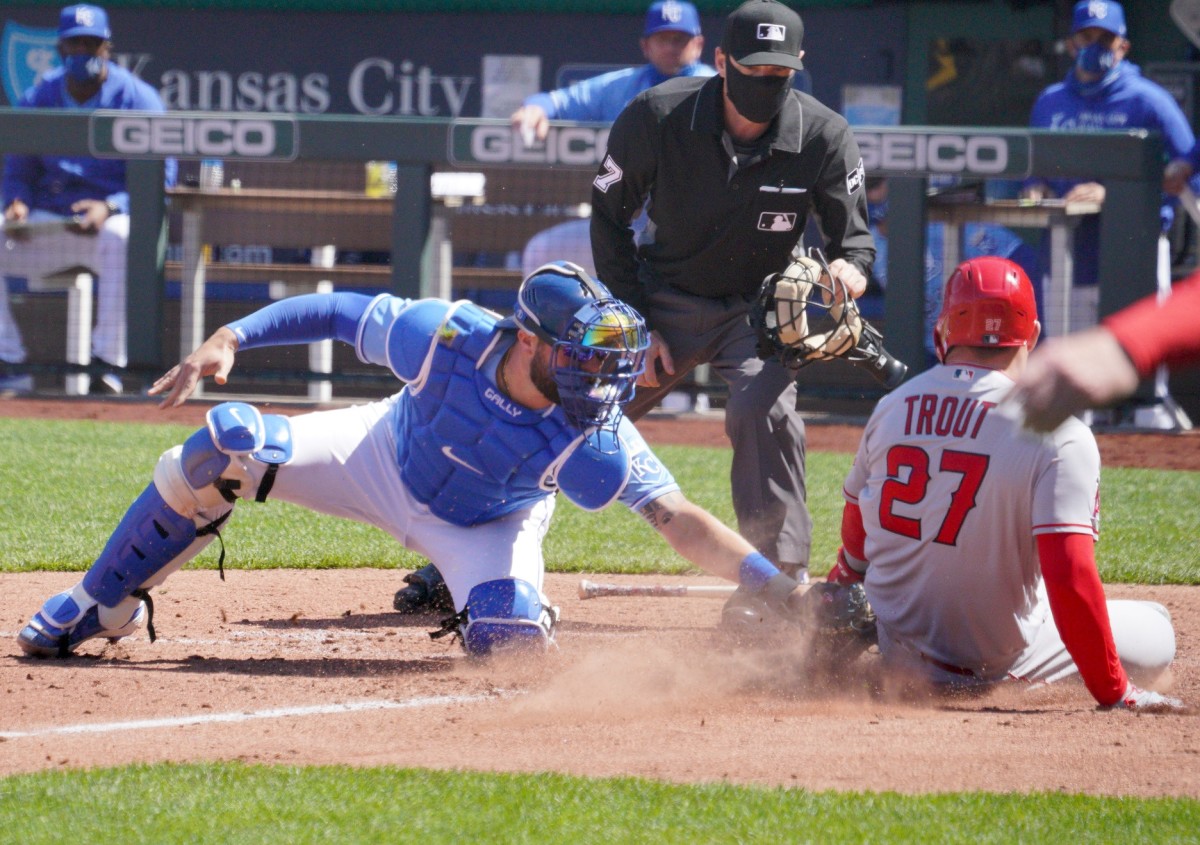 Apr 14, 2021; Kansas City, Missouri, USA; Kansas City Royals catcher Cam Gallagher (36) misses the ball and the tag on Los Angeles Angels center fielder Mike Trout (27) at the plate in the sixth inning at Kauffman Stadium. Mandatory Credit: Denny Medley-USA TODAY Sports