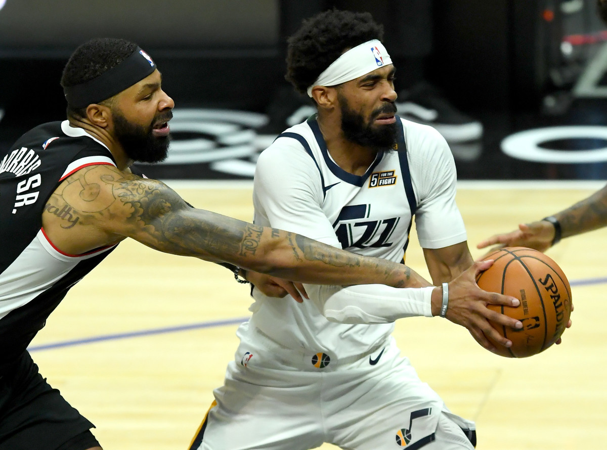 Feb 19, 2021; Los Angeles, California, USA; Los Angeles Clippers forward Marcus Morris Sr. (8) defends Utah Jazz guard Mike Conley (10) as he drives to the basket in the second half of the game at Staples Center. Mandatory Credit: Jayne Kamin-Oncea-USA TODAY Sports