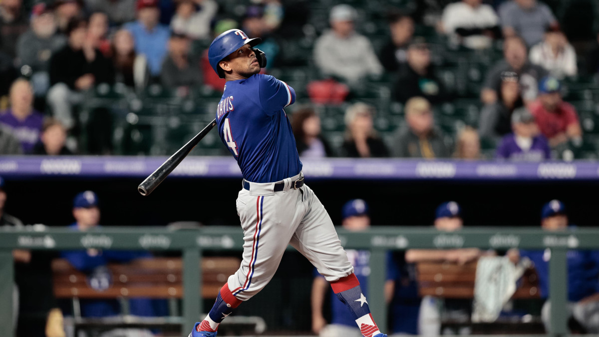 Jun 1, 2021; Denver, Colorado, USA; Texas Rangers pinch hitter Khris Davis (4) watches his ball on a solo home run in the eighth inning against the Colorado Rockies at Coors Field.