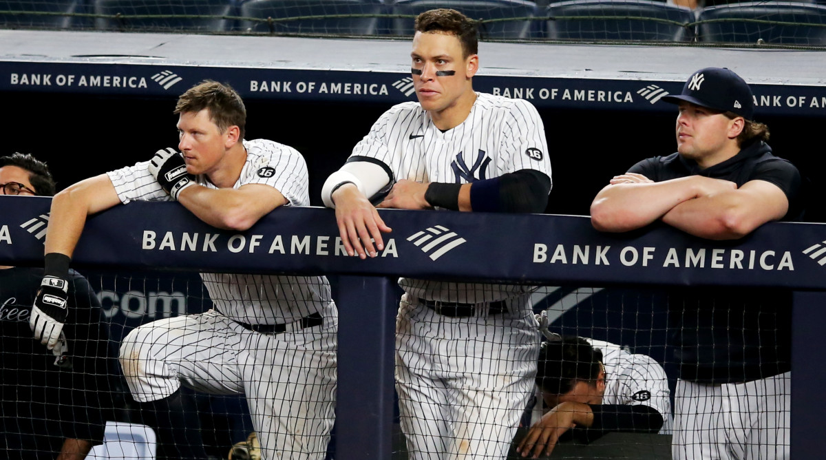 Jun 4, 2021; Bronx, New York, USA; New York Yankees first baseman DJ LeMahieu (26) and right fielder Aaron Judge (99) and injured first baseman Luke Voit (59) look on from the dugout during the ninth inning against the Boston Red Sox at Yankee Stadium.