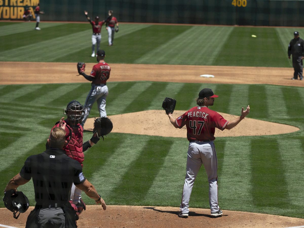 Arizona Diamondbacks starting pitcher Matt Peacock (47) reacts to a safe call by umpires after center fielder Ketel Marte appeared to catch a deep fly ball by Oakland Athletics center fielder Mark Canha.