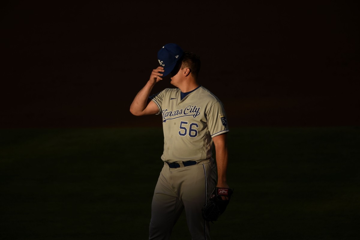 Jun 9, 2021; Anaheim, California, USA; Kansas City Royals starting pitcher Brad Keller (56) puts on his hat during the second inning against the Los Angeles Angels at Angel Stadium. Mandatory Credit: Kelvin Kuo-USA TODAY Sports