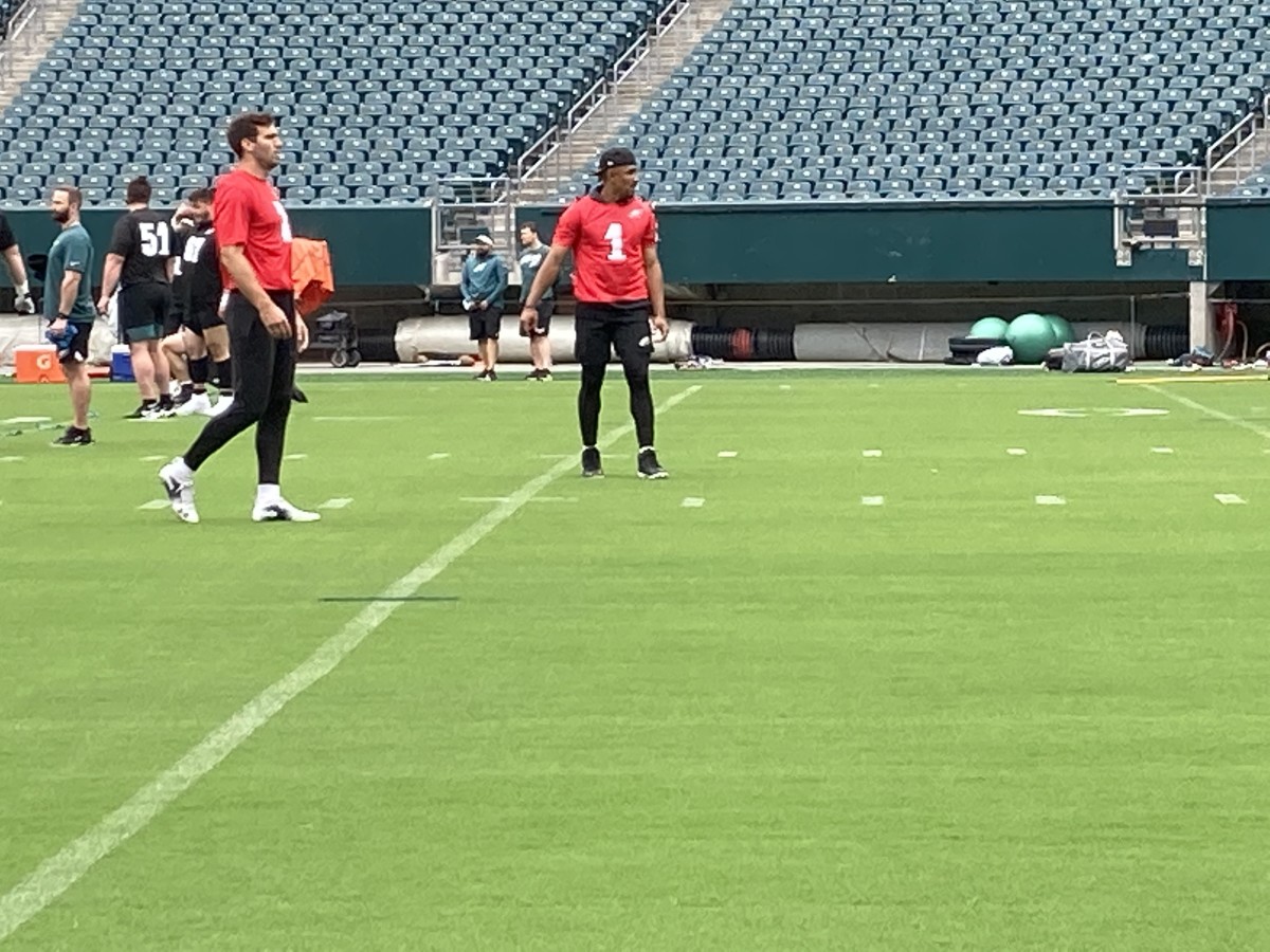 Eagles QBs Joe Flacco (left) and Jalen Hurts warm up prior to practice on June 4, 2021
