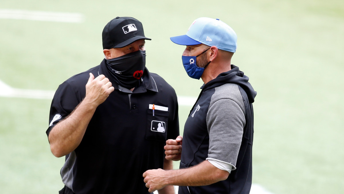 May 2, 2021; Arlington, Texas, USA; Texas Rangers manager Chris Woodward (8) talks to home plate umpire Brian O'Nora (7) about a call in the game against the Boston Red Sox at Globe Life Field.