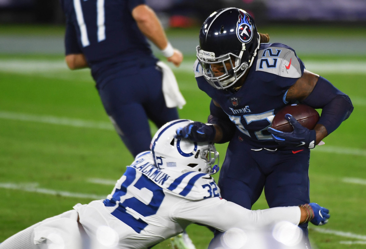 Nov 12, 2020; Nashville, Tennessee, USA; Tennessee Titans running back Derrick Henry (22) is stopped for a loss by Indianapolis Colts free safety Julian Blackmon (32) during the first half at Nissan Stadium.