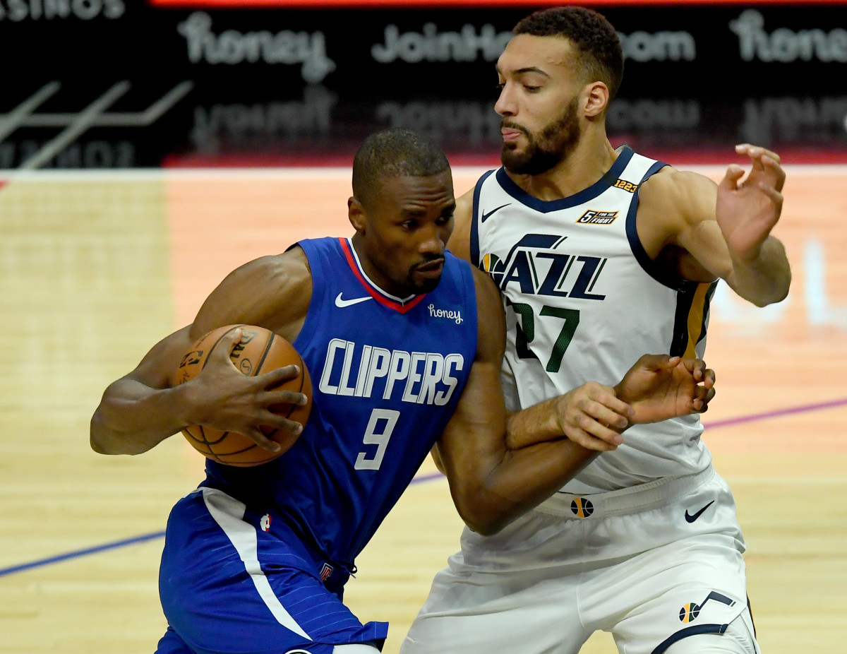 Feb 17, 2021; Los Angeles, California, USA; Los Angeles Clippers center Serge Ibaka (9) moves to the basket past Utah Jazz center Rudy Gobert (27) in the first half of the game at Staples Center. Mandatory Credit: Jayne Kamin-Oncea-USA TODAY Sports