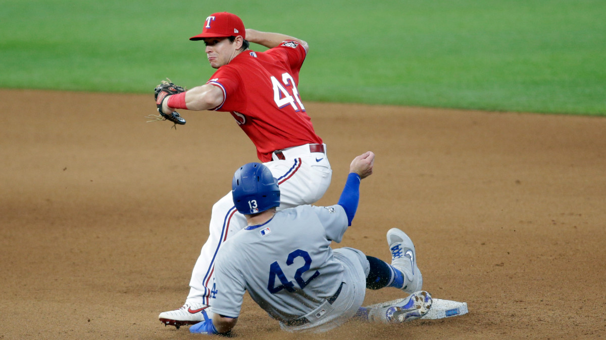 Aug 30, 2020; Arlington, Texas, USA; Texas Rangers second baseman Nick Solak (back) attempts to turn a double play on Los Angeles Dodgers third baseman Max Muncy (front) in the seventh inning at Globe Life Field.