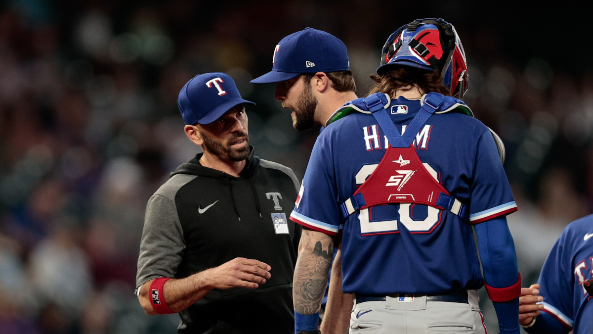 Jun 2, 2021; Denver, Colorado, USA; Texas Rangers starting pitcher Jordan Lyles (24) is pulled by manager Chris Woodward (8) ahead of catcher Jonah Heim (28) in the sixth inning against the Colorado Rockies at Coors Field.
