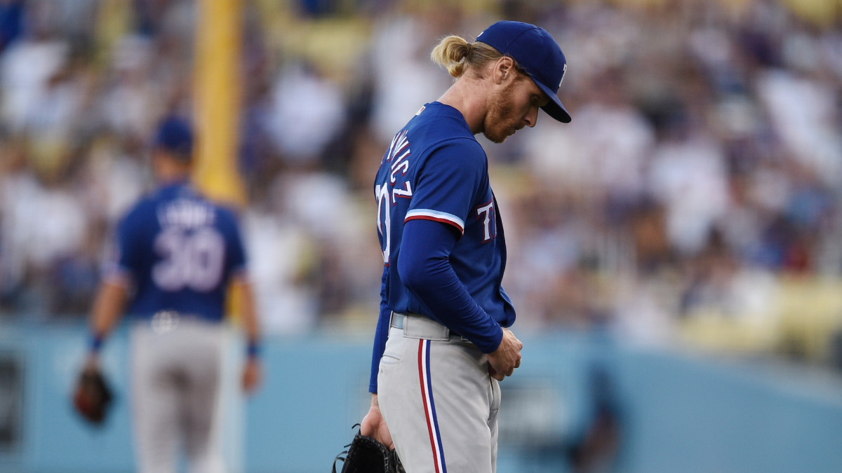 Jun 11, 2021; Los Angeles, California, USA; Texas Rangers starting pitcher Mike Foltynewicz (20) reacts after allowing a three-run home run to Los Angeles Dodgers shortstop Gavin Lux (9) during the first inning at Dodger Stadium.