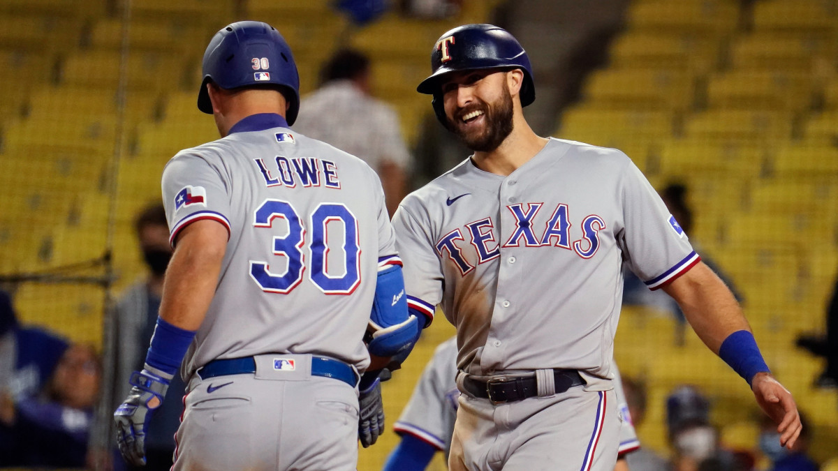 Jun 12, 2021; Los Angeles, California, USA; Texas Rangers center fielder Joey Gallo (13) is all smiles as he congratulates first baseman Nate Lowe (30) for his ninth inning home run against the Los Angeles Dodgers at Dodger Stadium.