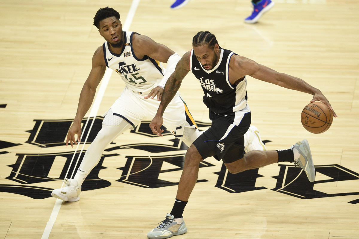 Jun 12, 2021; Los Angeles, California, USA; LA Clippers forward Kawhi Leonard (2) moves the ball while Utah Jazz guard Donovan Mitchell (45) defends in the third quarter during game three in the second round of the 2021 NBA Playoffs. at Staples Center. Mandatory Credit: Kelvin Kuo-USA TODAY Sports