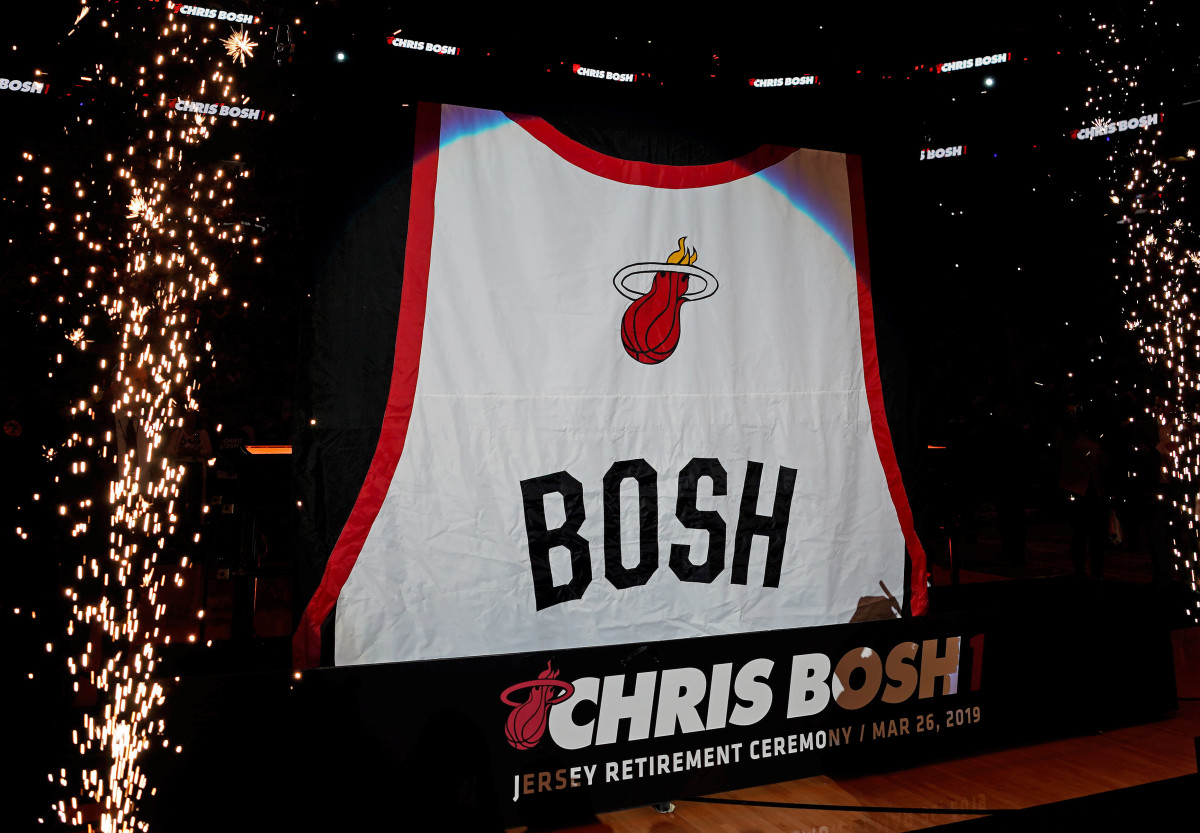 The jersey of former Miami Heat player Chris Bosh is lifted to the rafters during the jersey retirement ceremony at halftime of the game between the Miami Heat and the Orlando Magic at American Airlin...