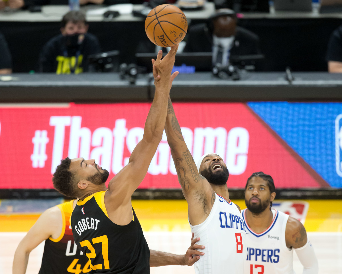 Jun 16, 2021; Salt Lake City, Utah, USA; Utah Jazz center Rudy Gobert (27) and LA Clippers forward Marcus Morris Sr. (8) compete for a jump ball to start game five in the second round of the 2021 NBA Playoffs at Vivint Arena. Mandatory Credit: Russell Isabella-USA TODAY Sports