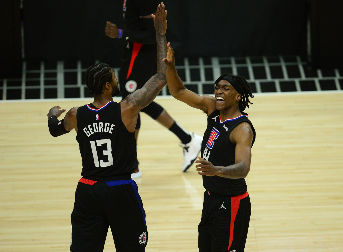 Jun 14, 2021; Los Angeles, California, USA; Los Angeles Clippers guard Terance Mann (14) reacts with guard Paul George (13) after scoring a basket and drawing a foul against the Utah Jazz during the first half in game four in the second round of the 2021 NBA Playoffs. at Staples Center. Mandatory Credit: Gary A. Vasquez-USA TODAY Sports