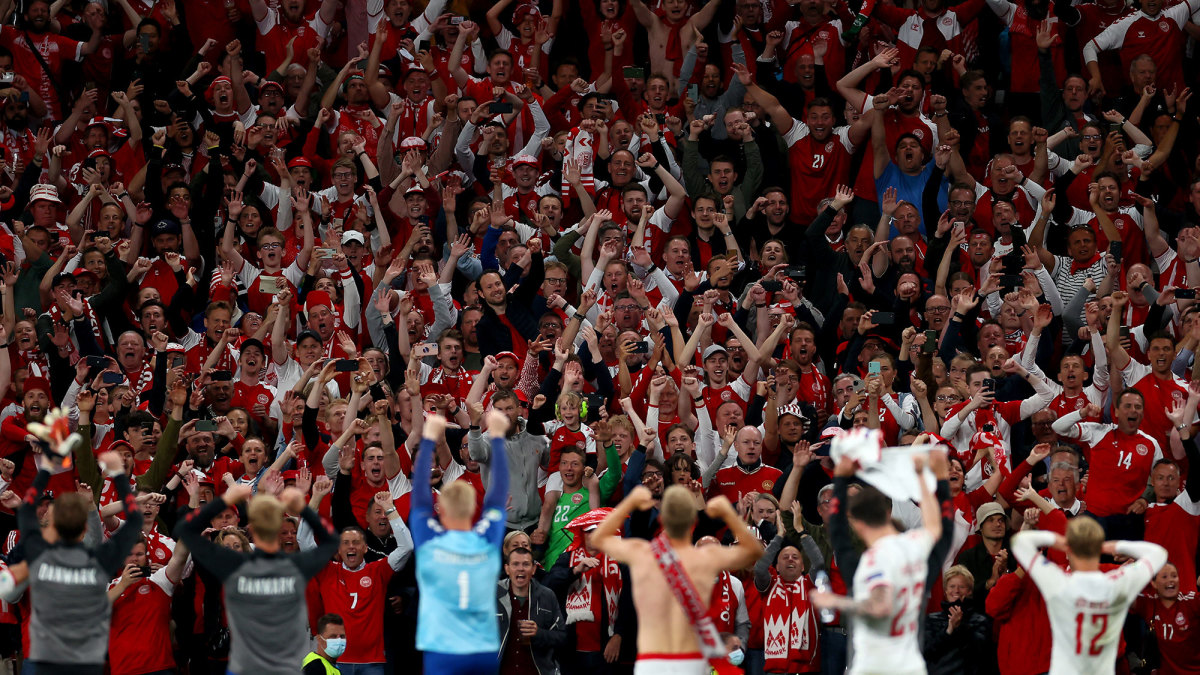 Denmark fans celebrate with players at Parken Stadium