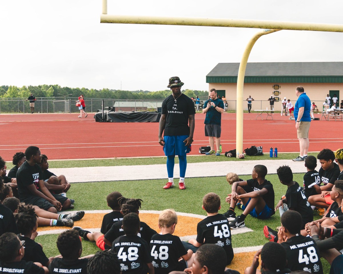 Giants linebacker Tae Crowder addresses school-aged children gathered for his recent one-day football camp held in his home state of Georgia.