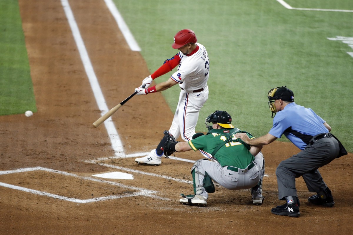 Jun 21, 2021; Arlington, Texas, USA; Texas Rangers first baseman Nate Lowe (30) hits a double in the first inning against the Oakland Athletics at Globe Life Field.