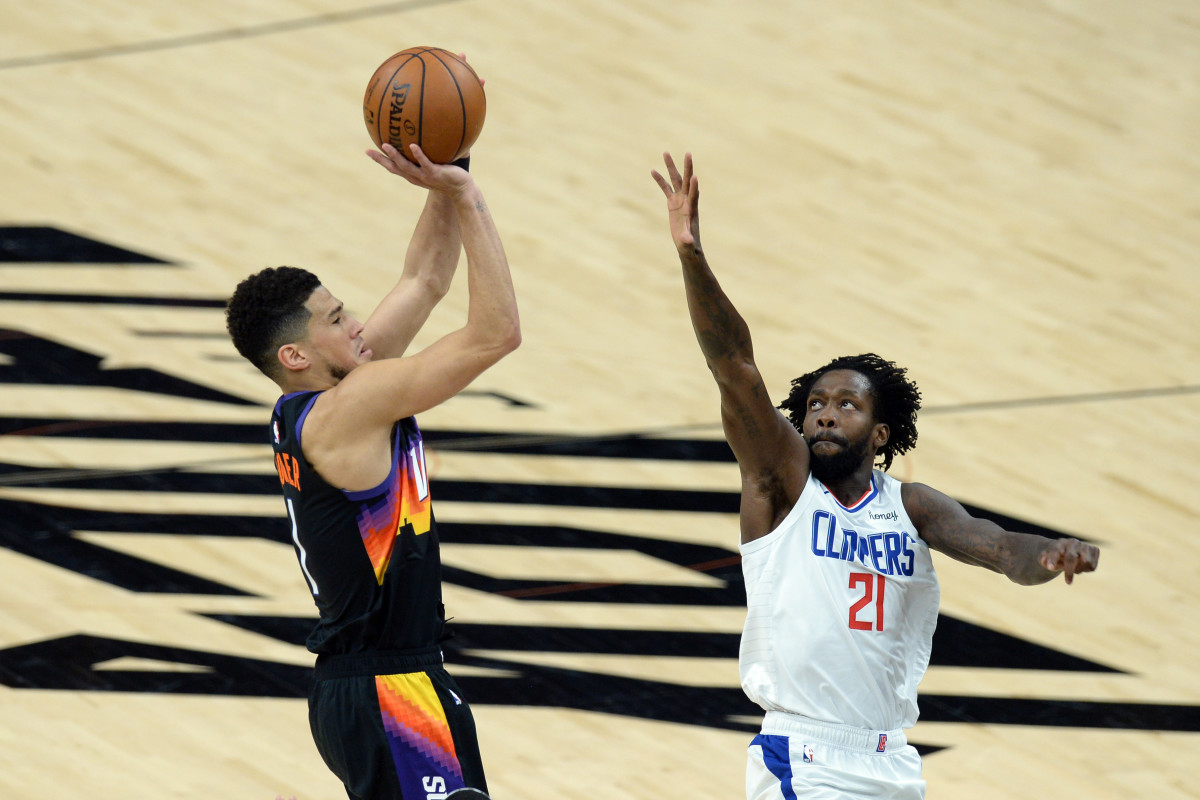 Jun 22, 2021; Phoenix, Arizona, USA; Phoenix Suns guard Devin Booker (1) shoots over LA Clippers guard Patrick Beverley (21) during the first half of game two of the Western Conference Finals for the 2021 NBA Playoffs at Phoenix Suns Arena. Mandatory Credit: Joe Camporeale-USA TODAY Sports