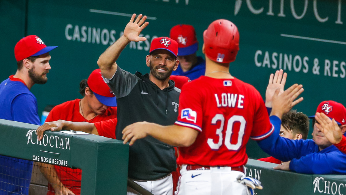 Jun 25, 2021; Arlington, Texas, USA; Texas Rangers manager Chris Woodward (8) congratulates first baseman Nate Lowe (30) after he comes in to score a run during the fourth inning against the Kansas City Royals at Globe Life Field.