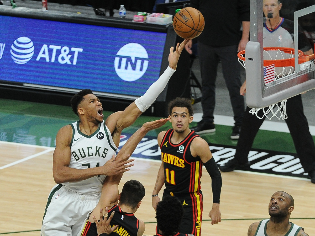 Milwaukee Bucks forward Giannis Antetokounmpo (34) shoots the ball over Atlanta Hawks guard Bogdan Bogdanovic (13) in the first quarter during game two of the Eastern Conference Finals