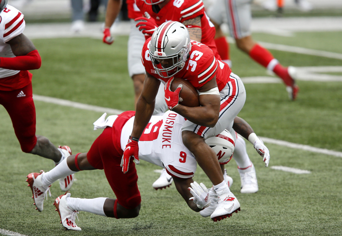 Ohio State's Master Teague is tackled by Nebraska safety Marquel Dismuke