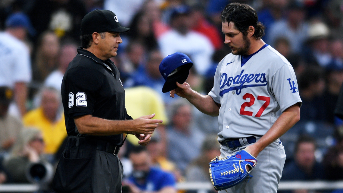 Jun 23, 2021; San Diego, California, USA; Los Angeles Dodgers starting pitcher Trevor Bauer (27) is checked for unauthorized foreign substances by umpire James Hoye (92) during the first inning at Petco Park.