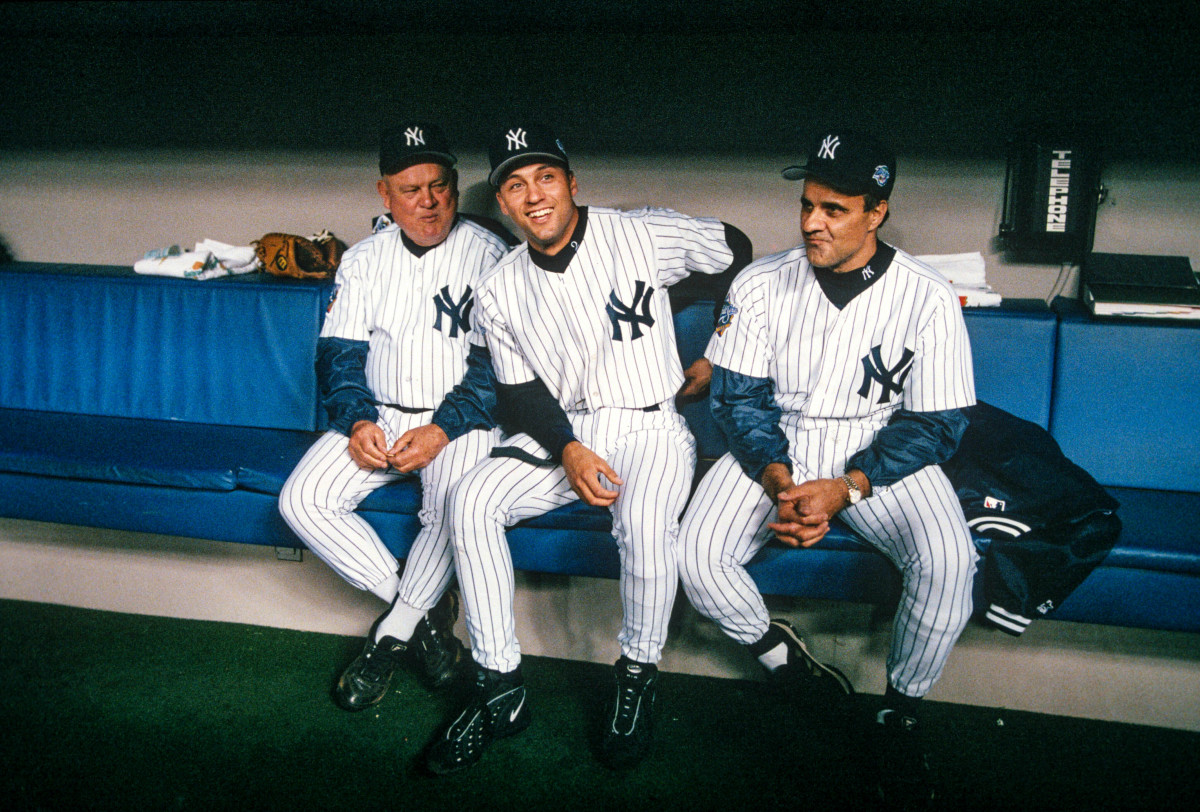 Derek Jeter sitting between Yankees bench coach Don Zimmer (left) and manager Joe Torre (right).