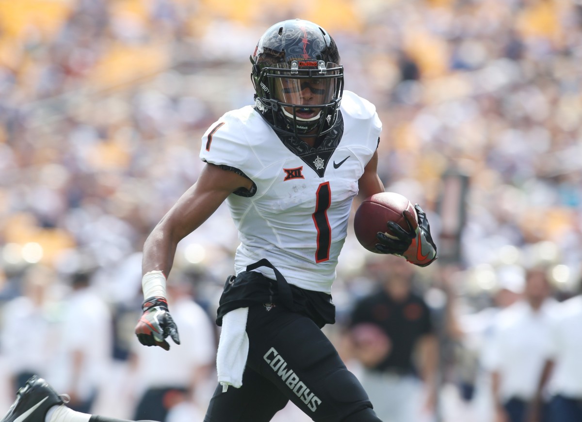 Oklahoma State receiver Jalen McCleskey (1) runs after a catch for a touchdown against the Pitt Panthers. Mandatory Credit: Charles LeClaire-USA TODAY Sports