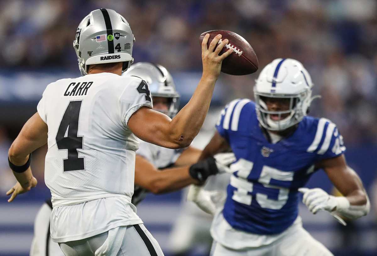 Right, Indianapolis Colts linebacker E.J. Speed (45) is held back as Oakland Raiders quarterback Derek Carr (4) passes in the second half of their game at Lucas Oil Stadium in Indianapolis, Sunday, Sept. 29, 2019. The Colts lost to the Raiders, 31-24. Oakland Raiders At Indianapolis Colts At Lucas Oil Stadium In Nfl Week 4 Sunday Sept 29 2019