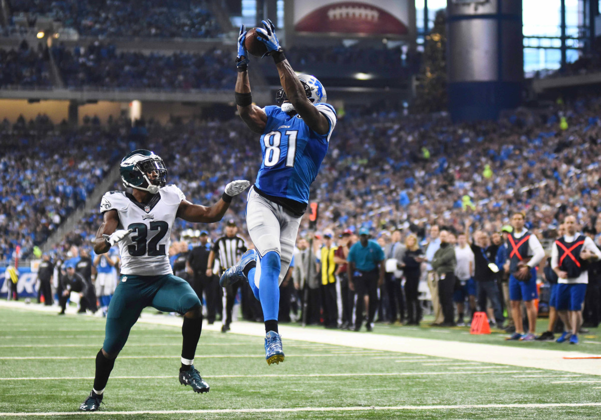 Lions wide receiver Calvin Johnson scores a touchdown while being pressured by Eagles cornerback Eric Rowe during the second quarter of a Thanksgiving Day game at Ford Field in 2015.