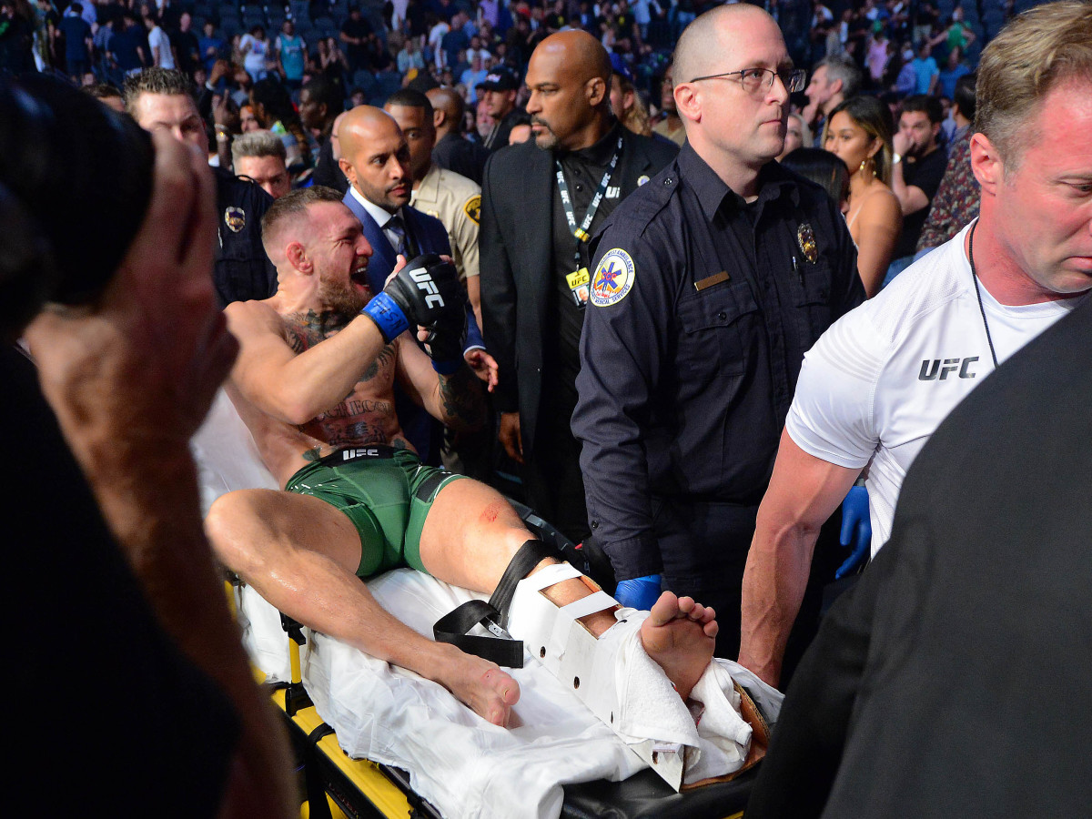Conor McGregor is carried off on a stretcher following an injury in his loss against Dustin Poirier during UFC 264 at T-Mobile Arena.