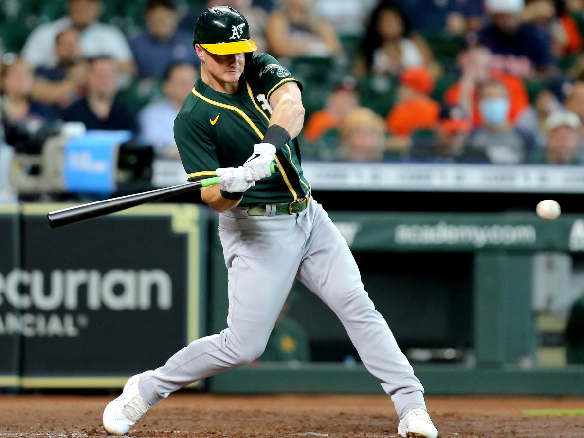 Jul 8, 2021; Houston, Texas, USA; Oakland Athletics third baseman Matt Chapman (26) hits a single against the Houston Astros during the fifth inning at Minute Maid Park.