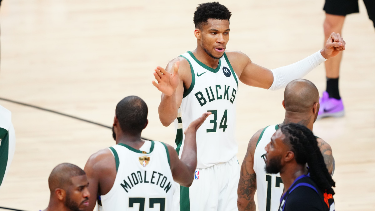 Milwaukee Bucks forward Giannis Antetokounmpo (34) celebrates with Milwaukee Bucks forward Khris Middleton (22) in the second half against the Phoenix Suns during game five of the 2021 NBA Finals