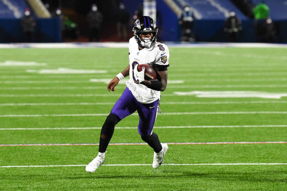 Jan 16, 2021; Orchard Park, New York, USA; Baltimore Ravens quarterback Lamar Jackson (8) runs with the ball against the Buffalo Bills during the third quarter of an AFC Divisional Round game at Bills Stadium. Mandatory Credit: Rich Barnes-USA TODAY Sports