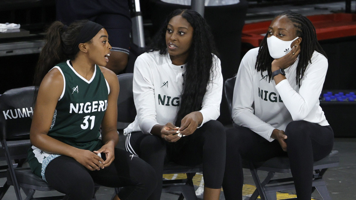 Erica Ogwumike (31) chats with sisters Chiney Ogwumike (center) and Nneka Ogwumike (right) during Nigeria's exhibition loss to U.S. women's basketball
