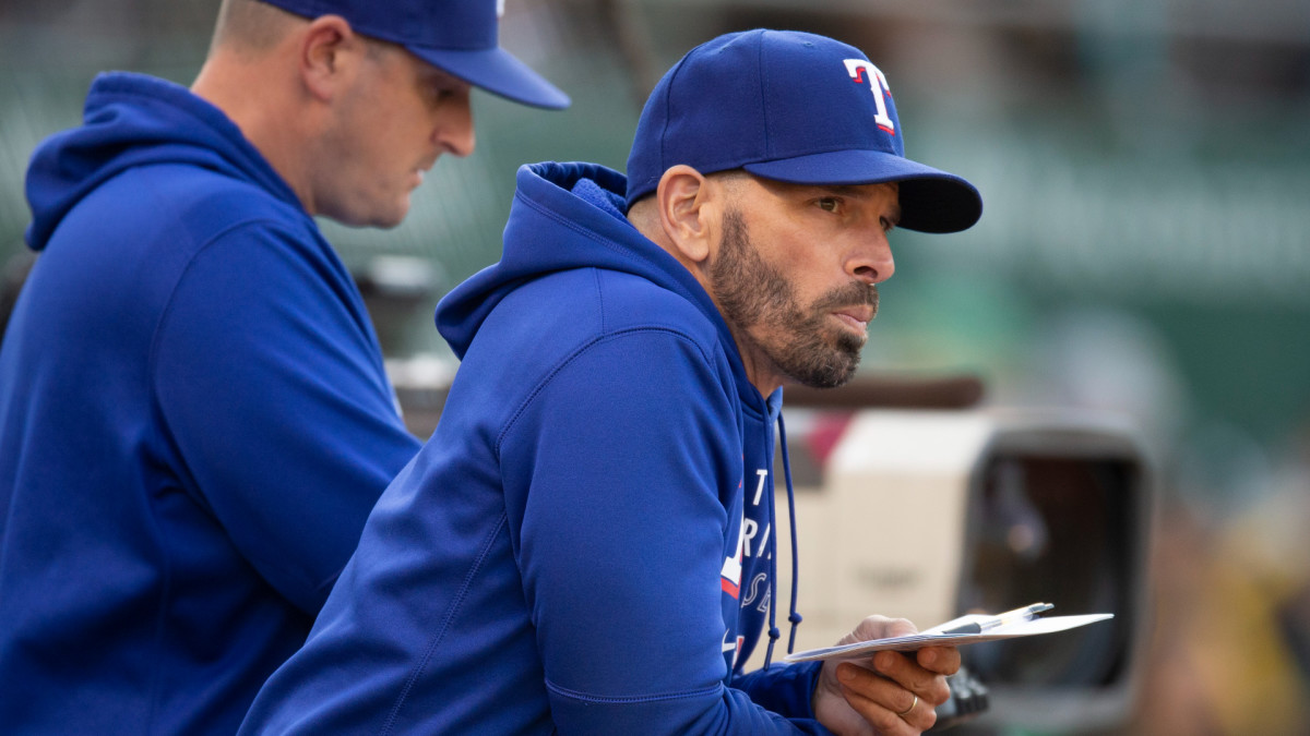 Jun 29, 2021; Oakland, California, USA; Texas Rangers manager Chris Woodward (right) watches his team take on the Oakland Athletics during the second inning at RingCentral Coliseum.